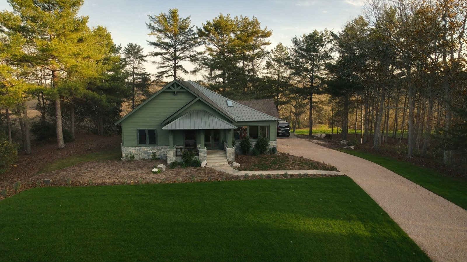 Aerial view of a custom home on wooded acreage in Powhatan