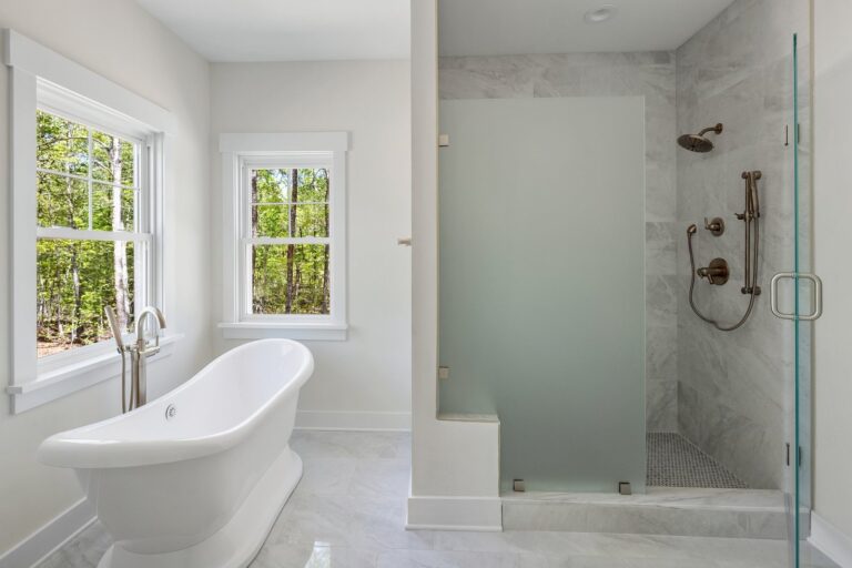 Primary bath with a freestanding tub and a walk-in shower in The Augusta