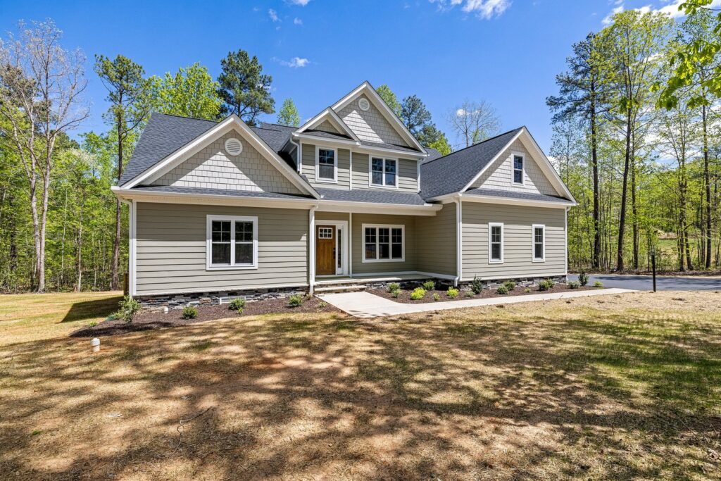 Front elevation of The Augusta with a stone porch on Maple Lake Road in Powhatan
