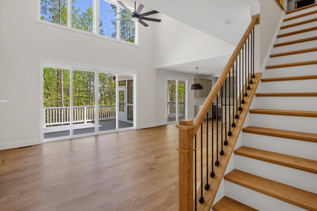 Stair hall with an open railing and hardwood floors in The Augusta