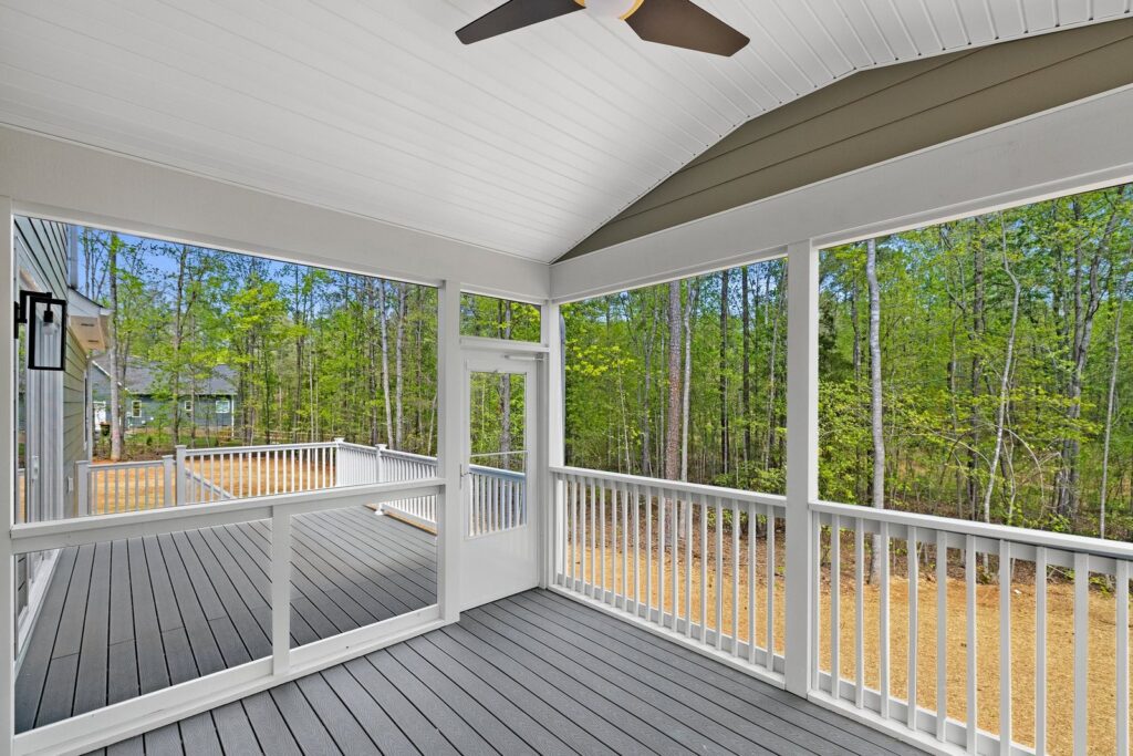 Screened porch overlooking the woods in The Augusta