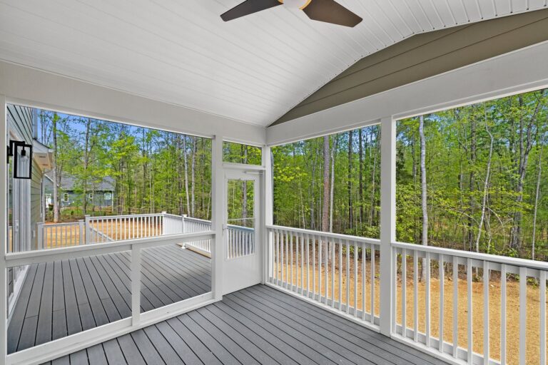 Screened porch overlooking the woods in The Augusta