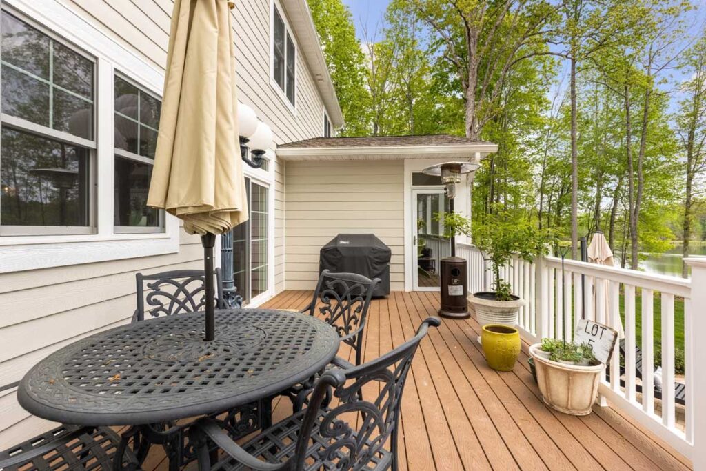 Deck with a dining table and lake view in The Hogan