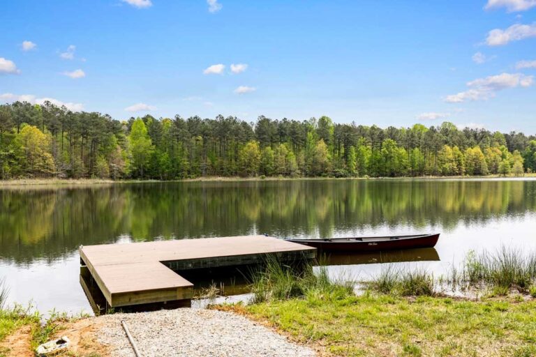 A wooden dock on a lake beside a Ridout homesite in Powhatan