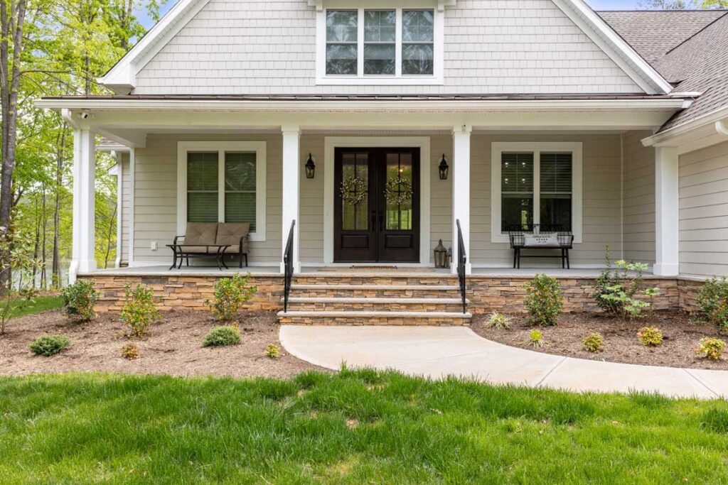 Front porch with a bench and stone steps in The Hogan