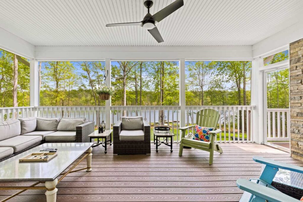 Screened porch with a sectional and a view of the lake in The Hogan