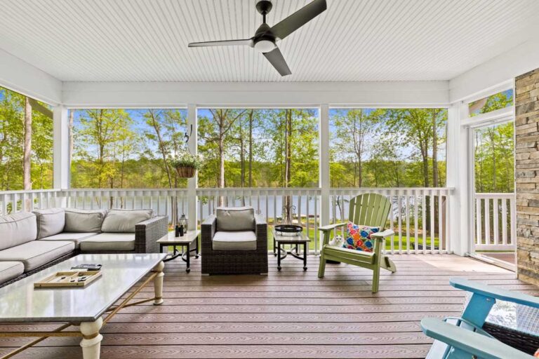 Screened porch with a sectional and a view of the lake in The Hogan