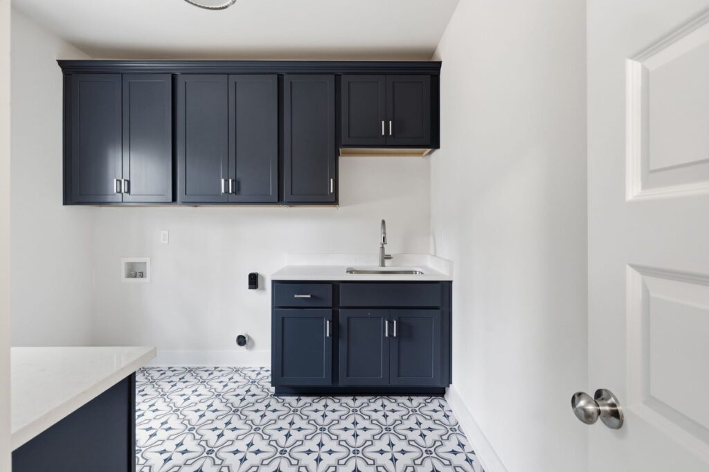 Mudroom with navy cabinets and patterned tile in The McIlroy