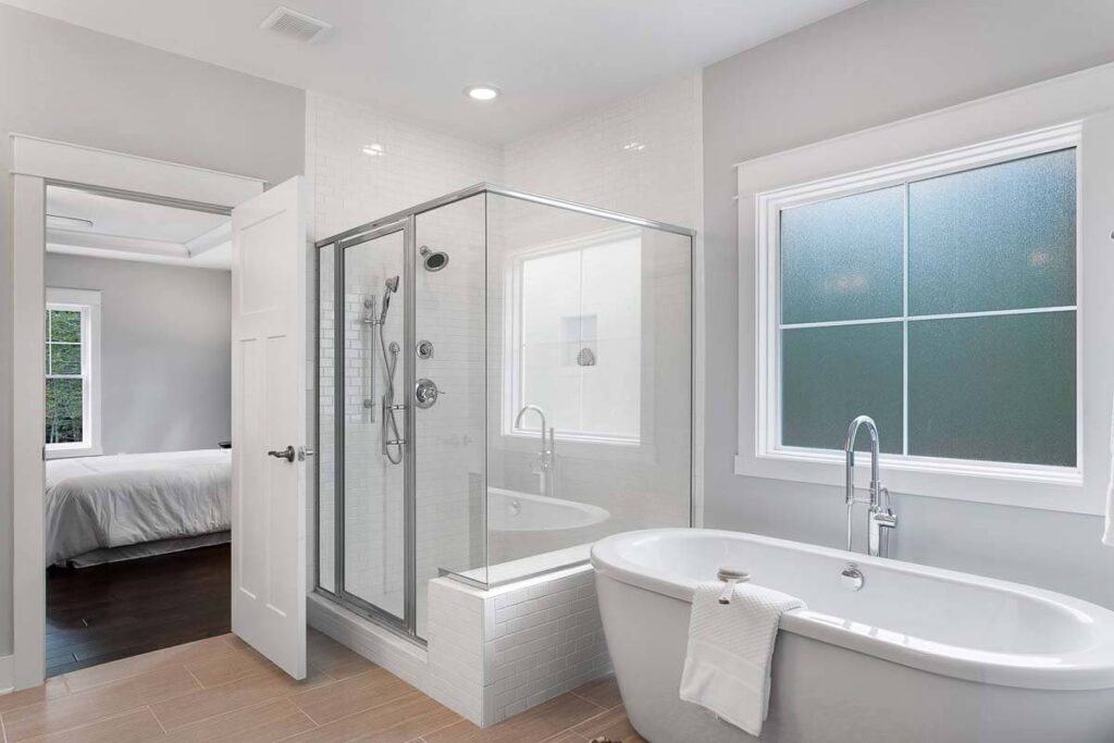 Primary bath with a freestanding tub and a glass shower in The O'Meara