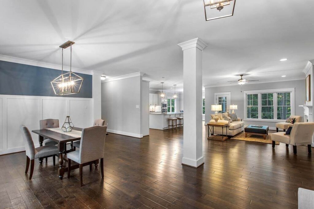 Dining room with a coffered ceiling and columns opening to the family room in The O'Meara