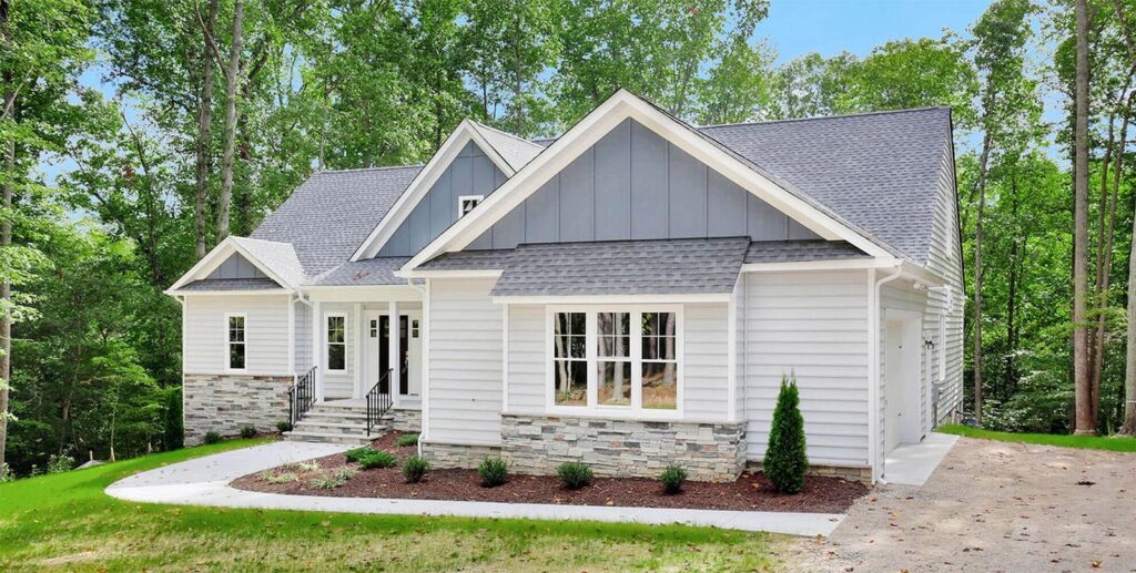 A white O'Meara with a gray roof and a long front porch