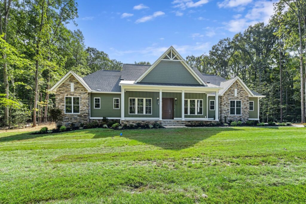 Front elevation of The Palmer with its covered porch and stone accents in Powhatan