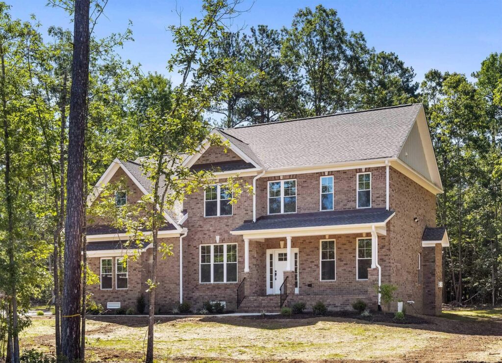 The Player, a brick two-story Ridout custom home on a wooded lot